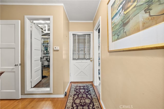 entryway featuring light hardwood / wood-style floors and ornamental molding