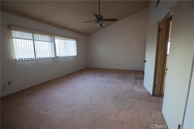 spare room with ceiling fan, light carpet, high vaulted ceiling, and a textured ceiling