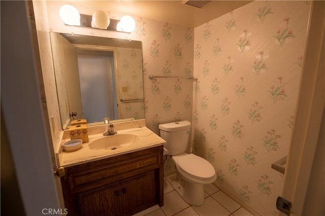 bathroom featuring toilet, vanity, and tile patterned flooring