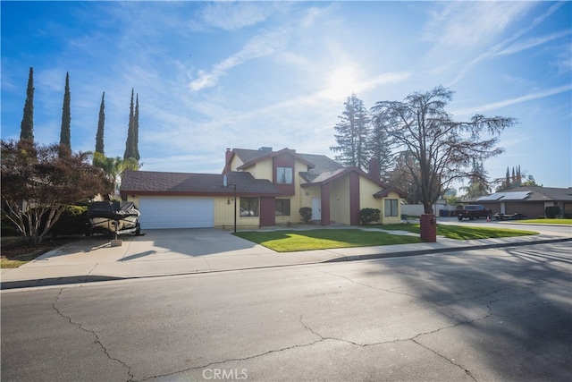 view of front facade with driveway, a front yard, and a garage