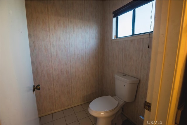 bathroom featuring toilet and tile patterned flooring