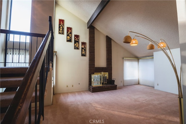 unfurnished living room with a healthy amount of sunlight, carpet flooring, and a textured ceiling