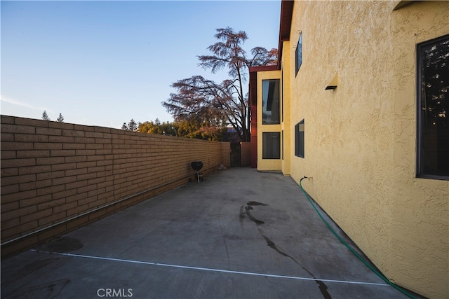 view of property exterior with a patio area