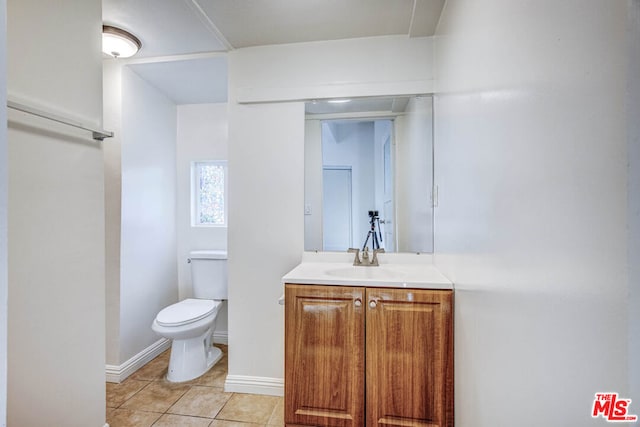 bathroom featuring tile patterned flooring, vanity, and toilet