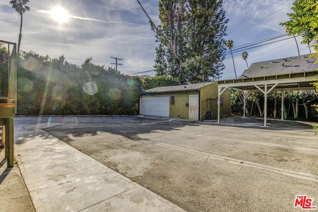 exterior space featuring a garage and a carport