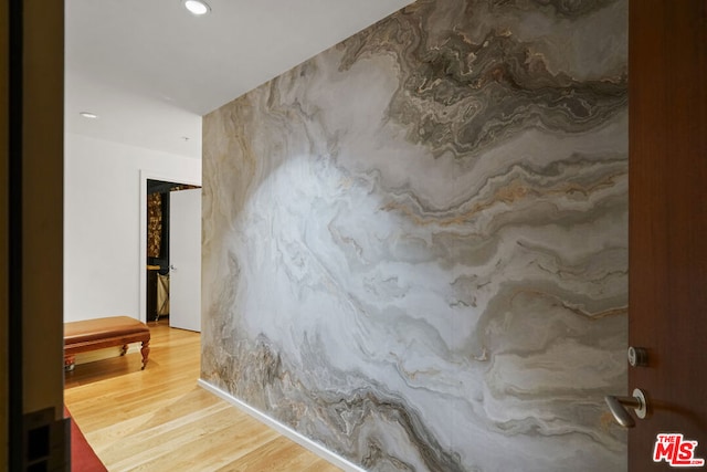 hallway with hardwood / wood-style flooring