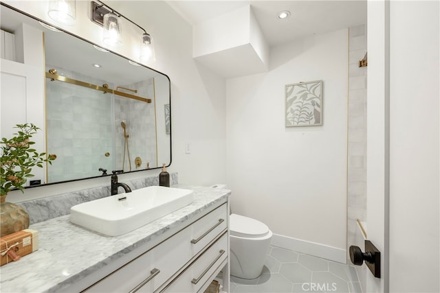 bathroom with tile patterned flooring, vanity, toilet, and a shower with shower door