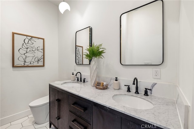 bathroom featuring tile patterned floors, vanity, and toilet