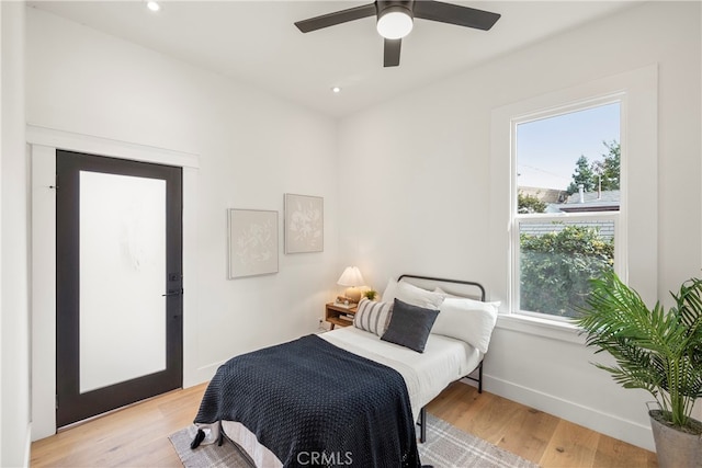 bedroom with ceiling fan and light hardwood / wood-style floors