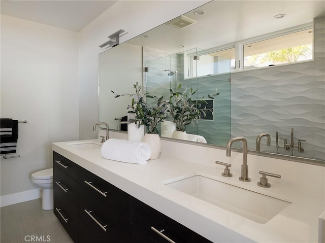 3100 Tennyson Pl, Hermosa Beach, CA 90254 - bathroom with double vanity, toilet, a shower stall, and baseboards