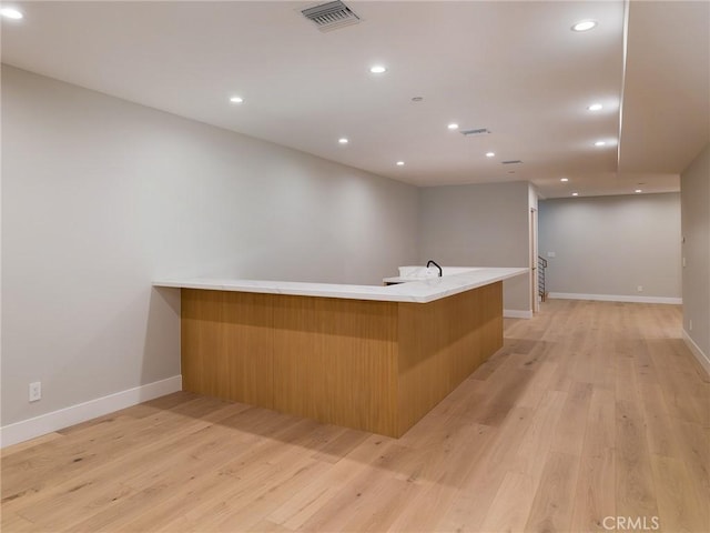 bar featuring light hardwood / wood-style flooring