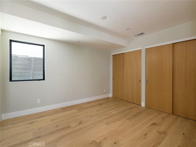 3100 Tennyson Pl, Hermosa Beach, CA 90254 - unfurnished bedroom with two closets, light wood finished floors, and baseboards