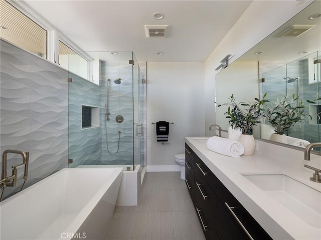 full bathroom with vanity, separate shower and tub, and toilet