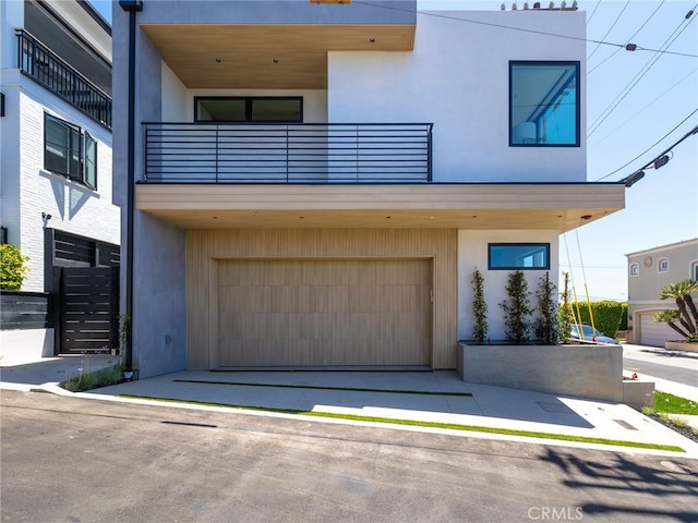 modern home with a garage and a balcony