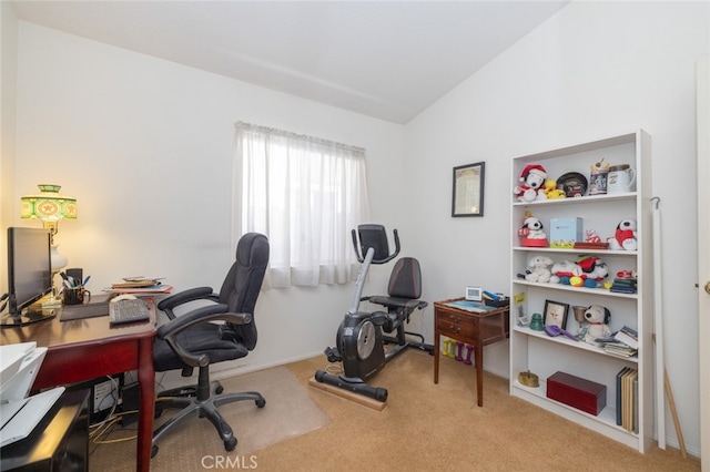 carpeted office featuring vaulted ceiling