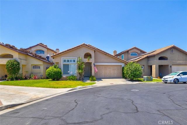 view of front of home with a front lawn and a garage