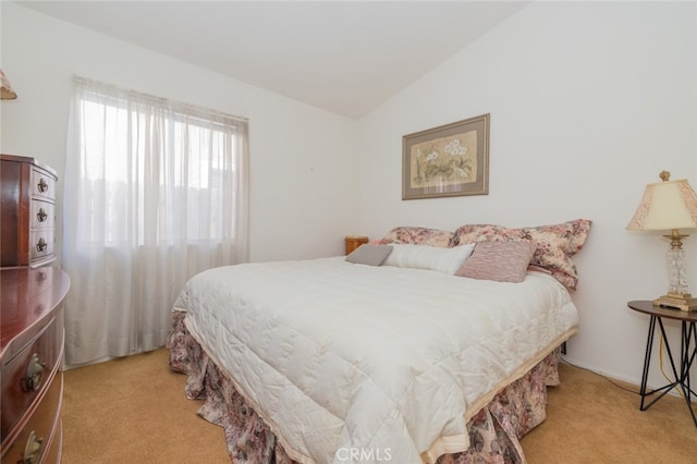 bedroom featuring vaulted ceiling and light carpet