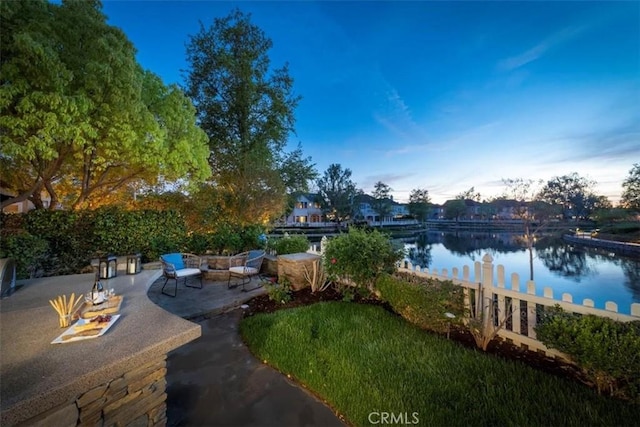 view of yard featuring a patio area and a water view