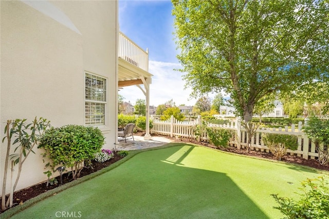 view of yard featuring a balcony and a patio