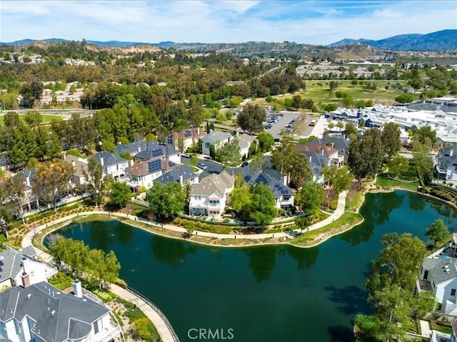 drone / aerial view featuring a water and mountain view