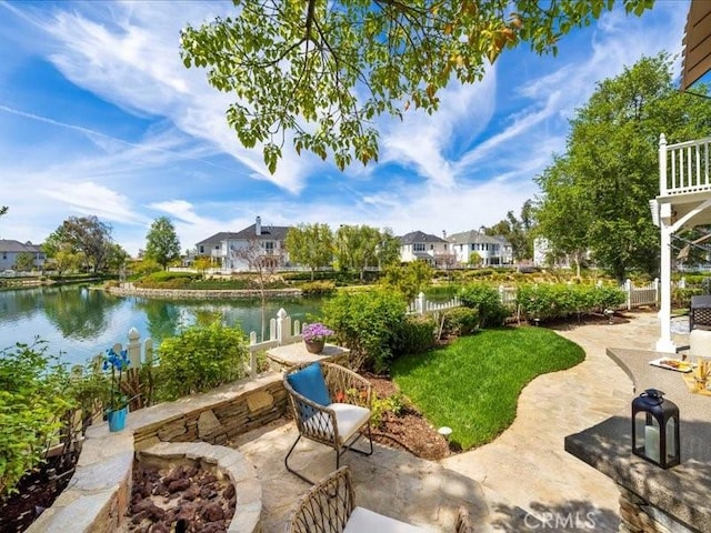 view of patio / terrace featuring a water view and an outdoor fire pit