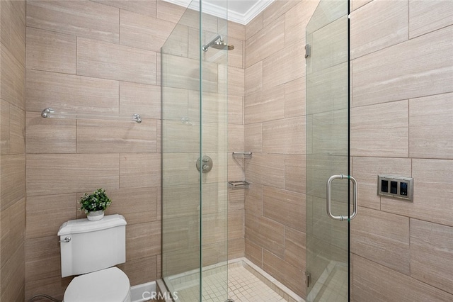 bathroom featuring toilet, a shower with door, and ornamental molding