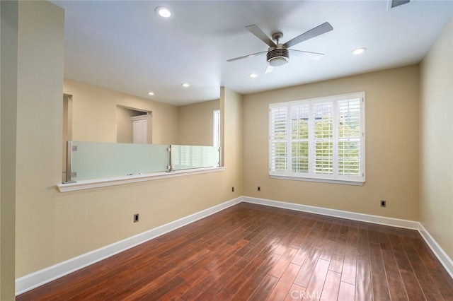 spare room featuring dark hardwood / wood-style floors and ceiling fan