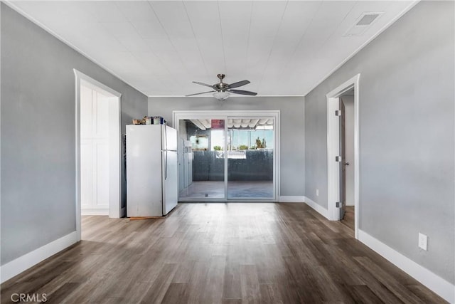 interior space featuring a ceiling fan, wood finished floors, visible vents, and baseboards