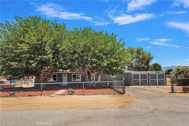 view of front of house featuring a fenced front yard and a gate