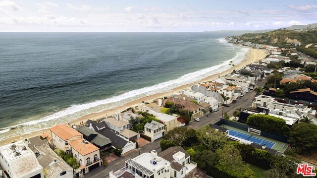 exterior space featuring a view of the beach and a water view