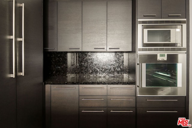 kitchen with decorative backsplash, dark stone countertops, appliances with stainless steel finishes, and gray cabinets