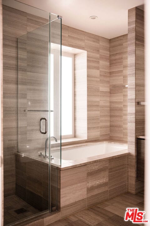 bathroom featuring separate shower and tub