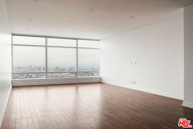 empty room with hardwood / wood-style floors