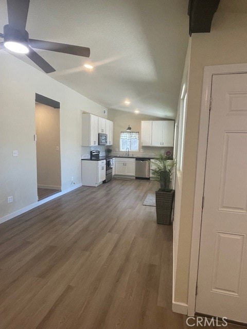 kitchen featuring sink, dark hardwood / wood-style flooring, white cabinetry, ceiling fan, and stainless steel appliances