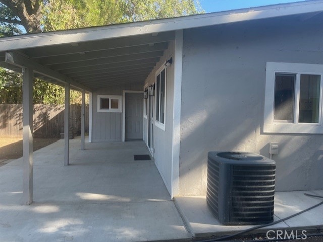 view of patio / terrace featuring central air condition unit and a carport