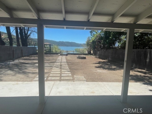 view of patio featuring a water and mountain view