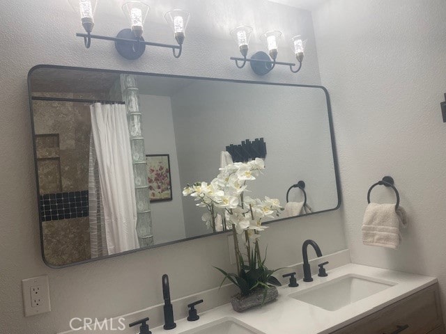 bathroom featuring vanity, a shower with shower curtain, and an inviting chandelier