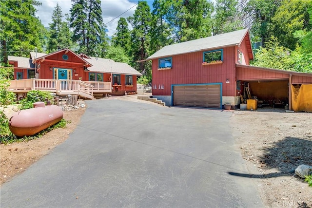 view of front of home with a deck and a garage