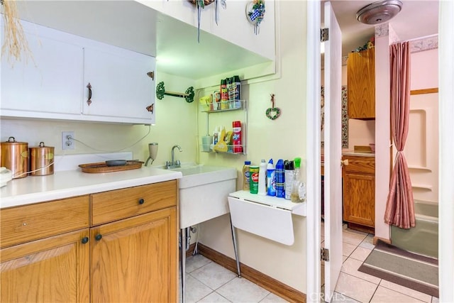 interior space featuring sink and light tile patterned floors