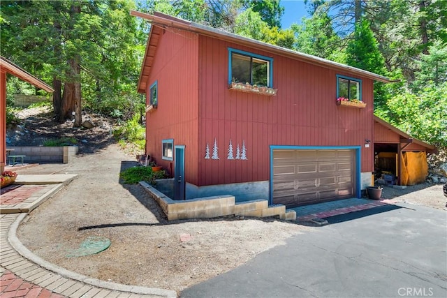 view of side of home with a garage