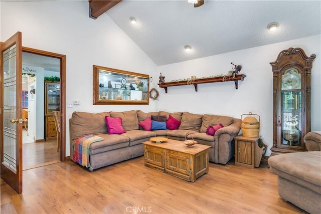 living room featuring high vaulted ceiling, beam ceiling, and light hardwood / wood-style floors