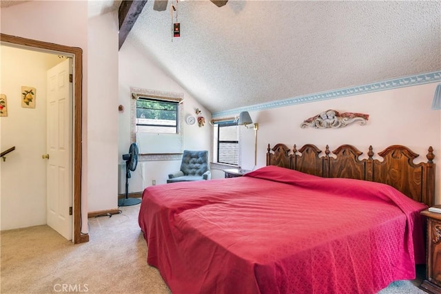 bedroom with light carpet, vaulted ceiling with beams, a textured ceiling, and ceiling fan