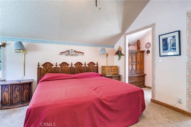 bedroom with vaulted ceiling, light carpet, and a textured ceiling