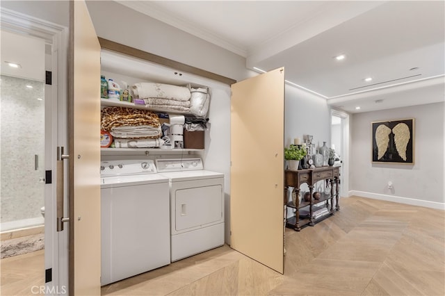 laundry area with washer and dryer and crown molding