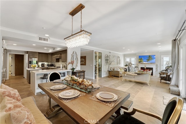 dining room with an inviting chandelier and crown molding