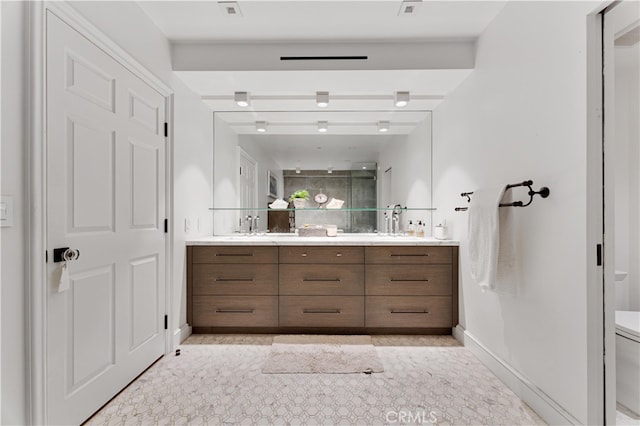 bathroom featuring vanity and a shower with shower door