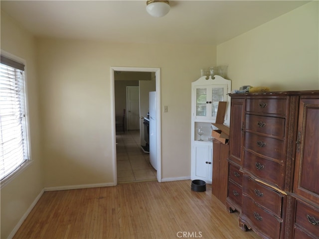 interior space with multiple windows and light hardwood / wood-style flooring