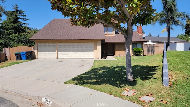 view of front of home featuring a front yard and a garage