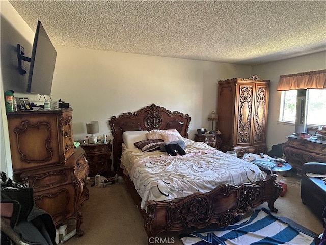 carpeted bedroom featuring a textured ceiling