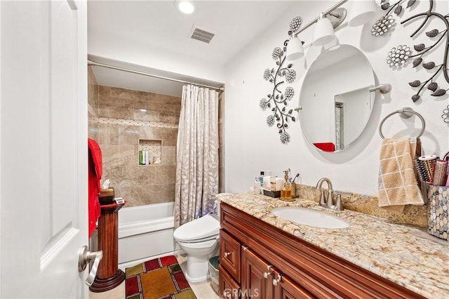 full bathroom with shower / tub combo with curtain, vanity, and toilet